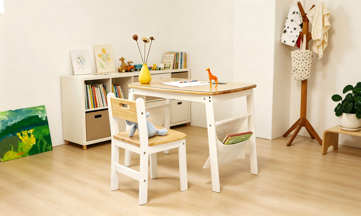 Dual-sided Montessori kids desk against a wall with hanging canvas side bags holding books and art supplies.
