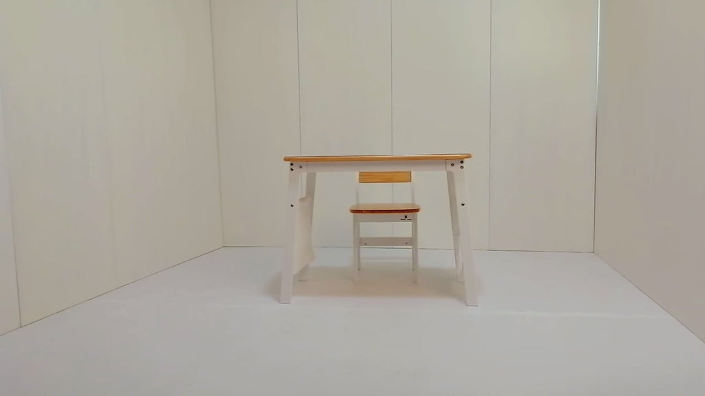 Smiling child drawing at 'My First Desk' with storage bags and PVC mat. Solid wood construction with rounded safety corners.