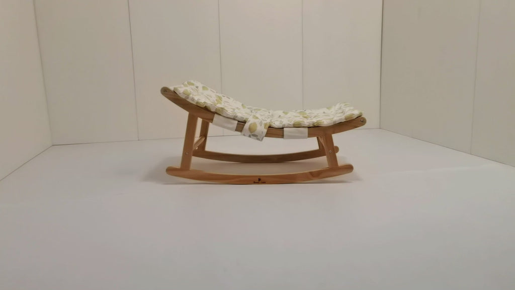 CPSC-certified baby lounger with gentle rocking motion: Newborn rests safely on breathable fabric as parent supervises awake time