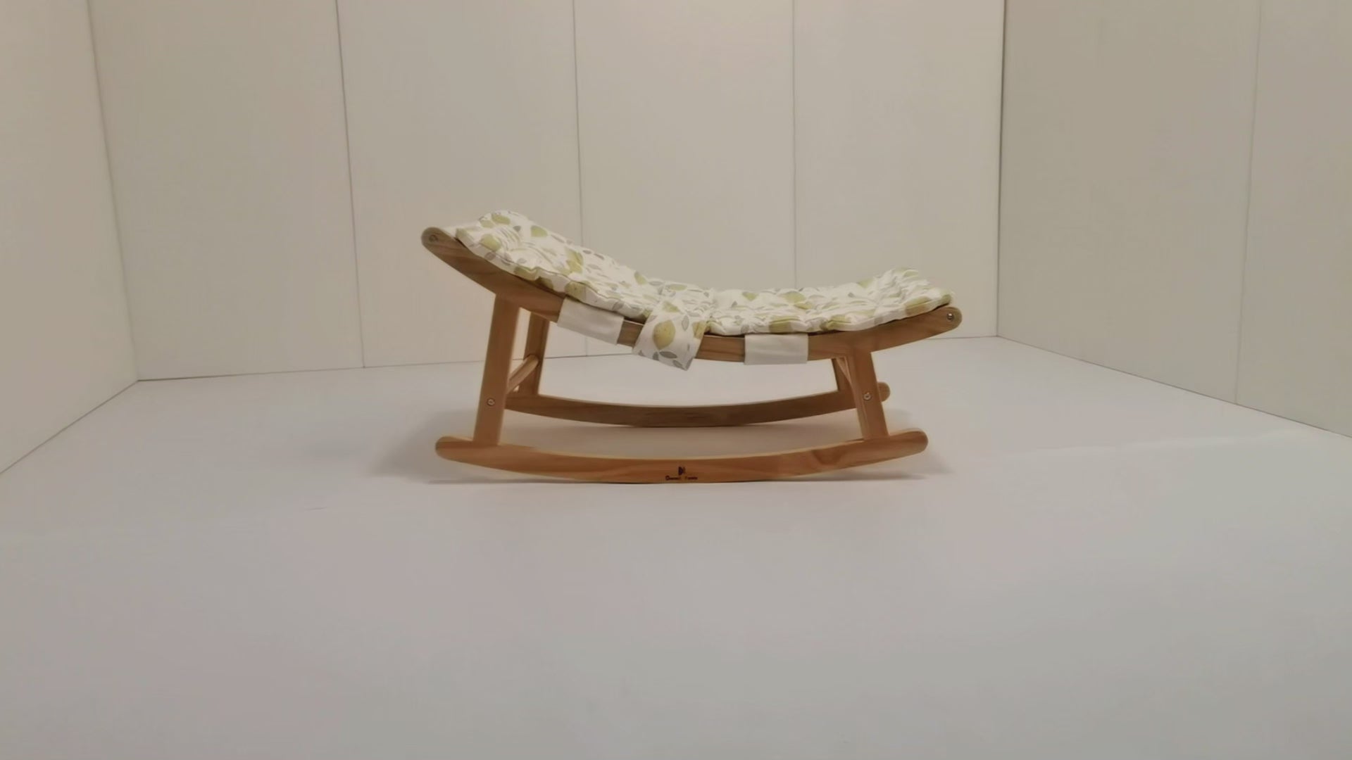 CPSC-certified baby lounger with gentle rocking motion: Newborn rests safely on breathable fabric as parent supervises awake time
